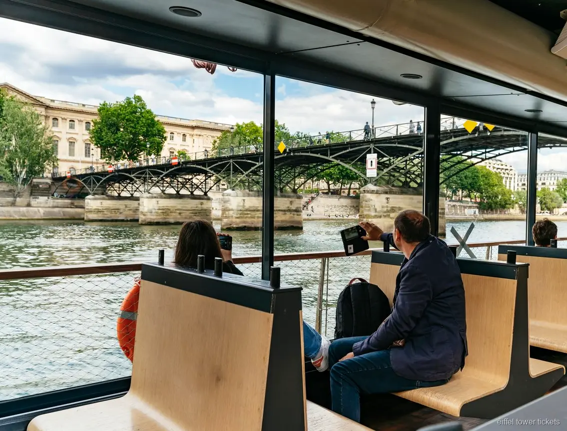 Eiffel Tower lit up as seen from a Seine River cruise